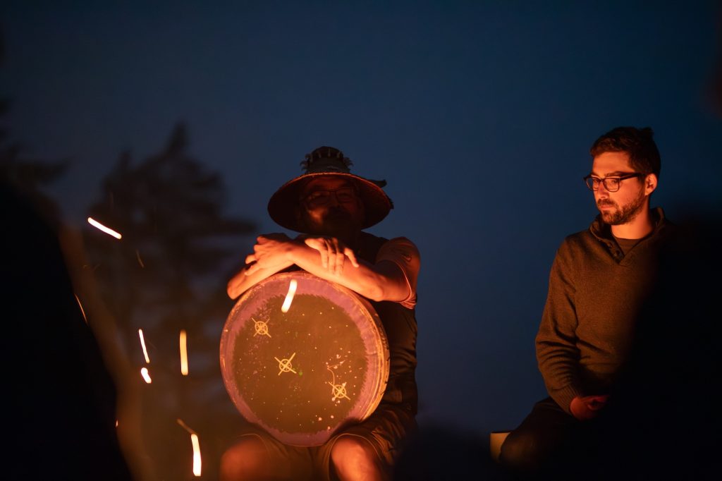 festival attendees at nigh with campfire